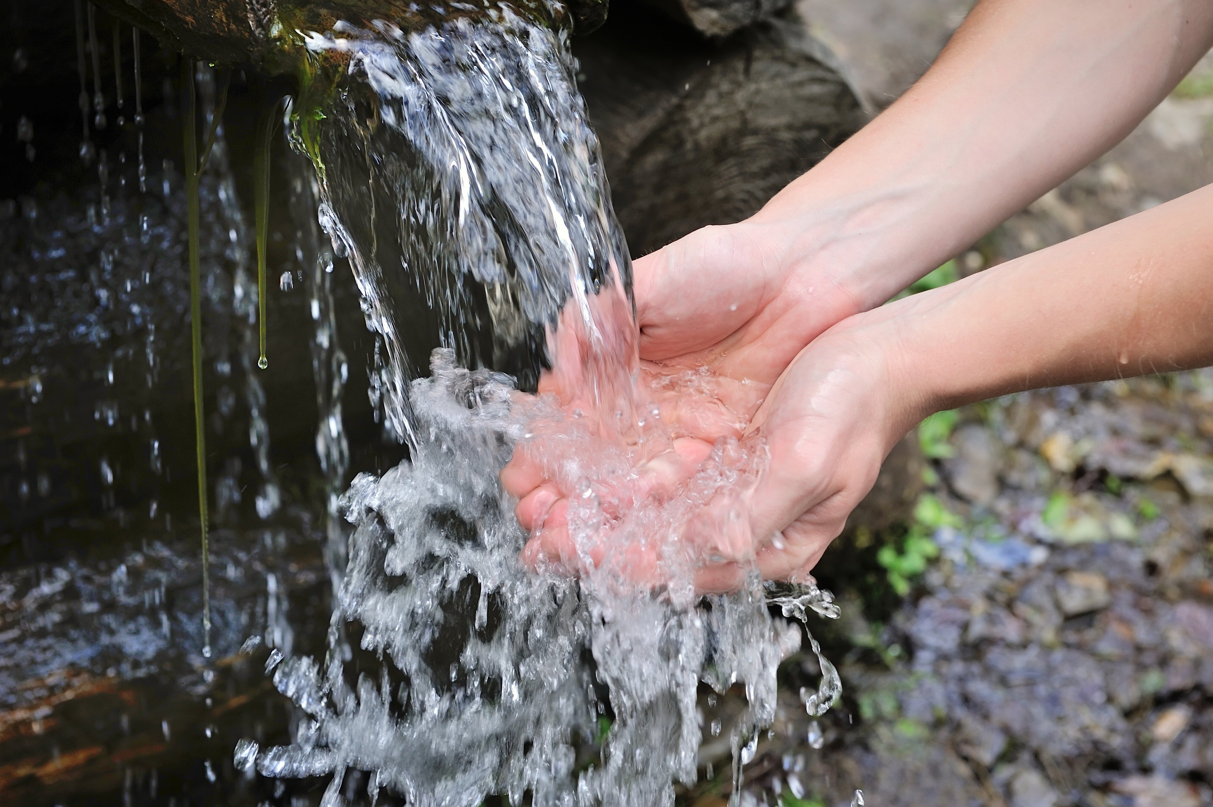 drinking-water-and-natural-water-in-the-hands-2021-08-26-18-28-18-utc